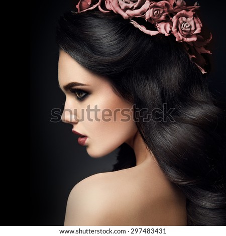 Beauty Fashion Model Girl Portrait with Roses Hairstyle. Red Lips.