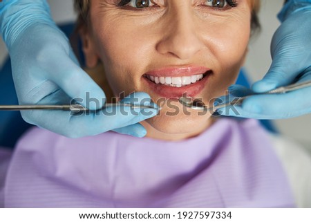 Similar – Image, Stock Photo Crop dentist examining teeth of patient in clinic