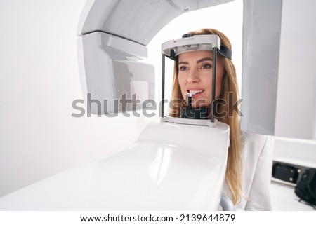 Woman using dental diagnostic equipment in stomatology clinic ストックフォト © 