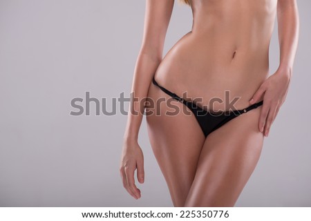 Half-length portrait of sexy beautiful woman with great figure wearing black lingerie showing the beauty of her wonderful body. Isolated on white background