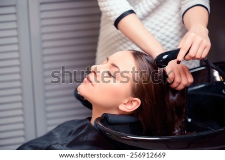 Wash away the stress. Cropped shot of a young woman having her hair washed at a professional hair salon