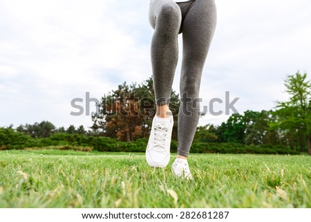 Jump up. Close-up portrait of slim sportive woman legs