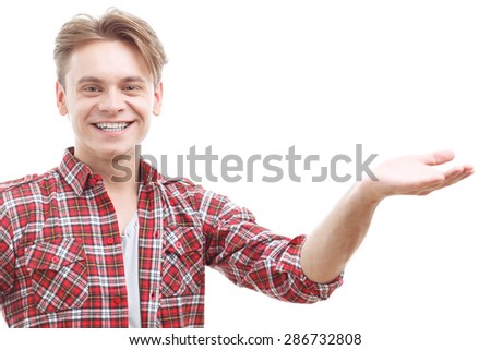 On the edge of joy. Young handsome guy rising the hand and expressing positivity while standing isolated on white background