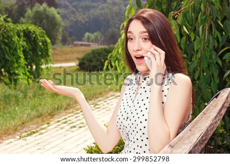 What a surprising news. Close up of pleasant surprised young girl talking on mobile phone and evincing wonder.