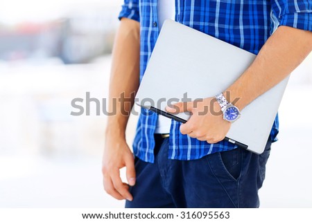 Modern guy. Close up of notebook in hands of professional worker holding it