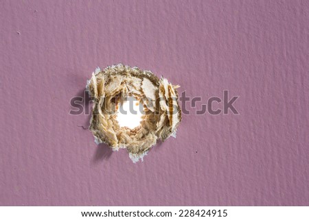 Bullet hole in painted wood