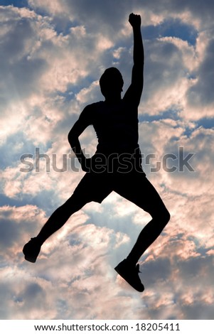 Silhouette of young man, jumping, against very cool sky