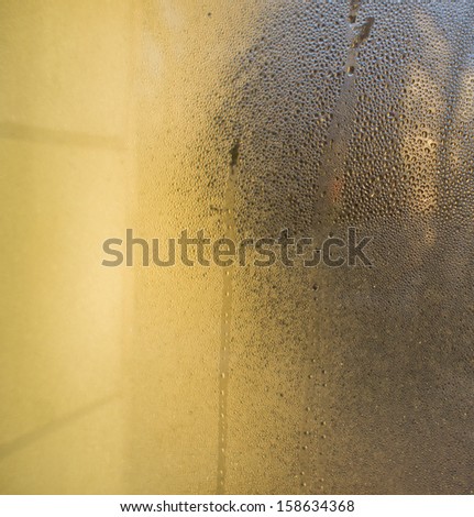 misted glass is covered with drops of water, sunny day