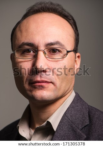 businessman in a suit and glasses looking at the camera, close up, age thirty-five, thirty-seven years