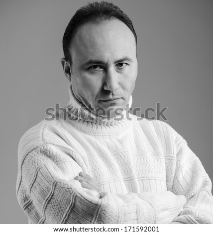 Portrait of a businessman in a sweater looking at the camera in disbelief, age thirty-five, thirty-seven years