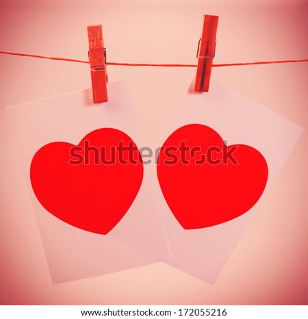 Two photos on a rope symbol Valentine pinned clothespins, closeup