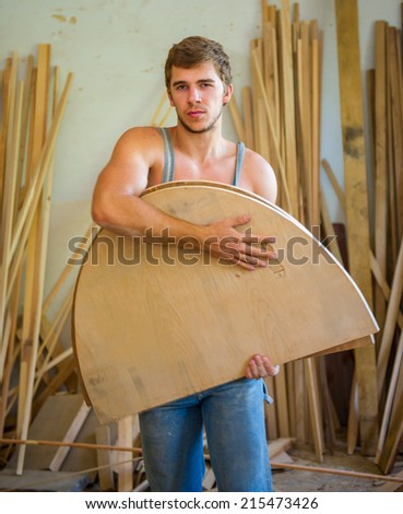 Portrait of a young man who keeps working wood products