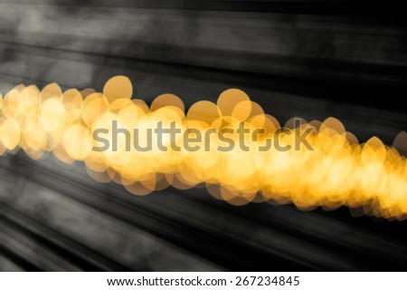 blurred spots and golden white light on a dark background
