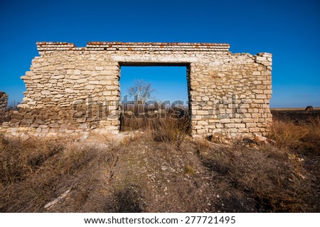 old ruined house in the countryside on a blue sky background
