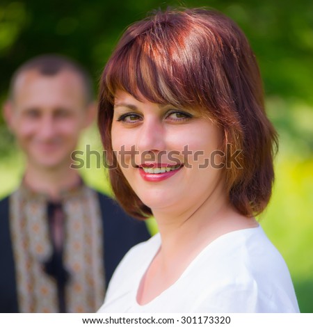 Portrait of a Ukrainian wife with his man in the countryside