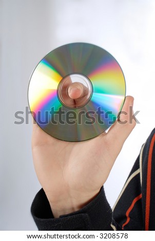 CD or DVD disc held in a male hand, close-up