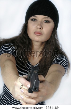 young woman with  pistol in hands on  white background