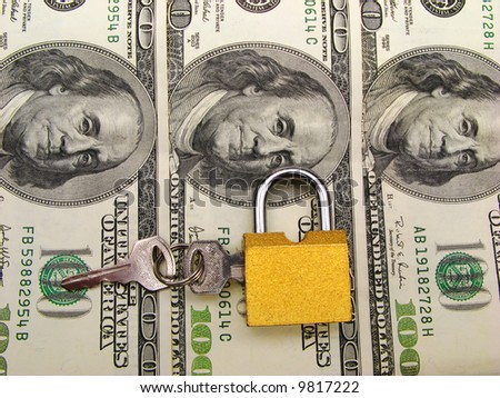 The lock with keys on  background of dollars,  close up