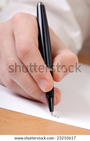 businessman holds hand in  black color pen and signs  document
