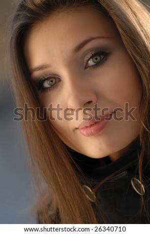 Portrait of  young nice girl at  daylight in natural conditions