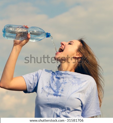 nice young beautiful woman drinks water and  plastic bottle