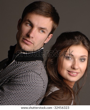 Pair nice young people on  dark background,  portrait