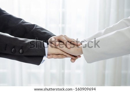 Business people hands on top of each others
