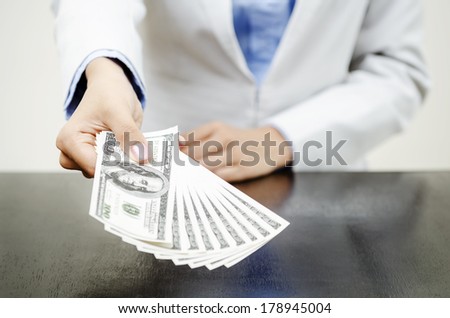 Money in hands of businesswoman