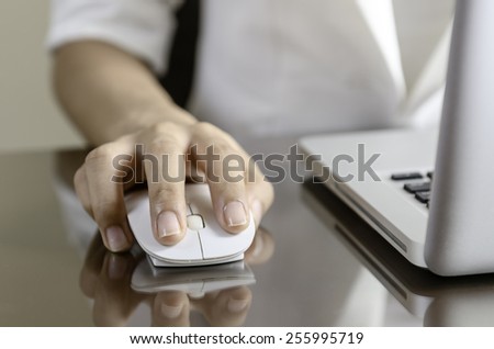Woman using a mouse working on the computer