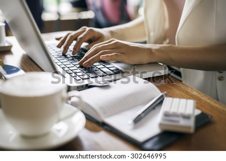 journalist typing document in a coffee shop