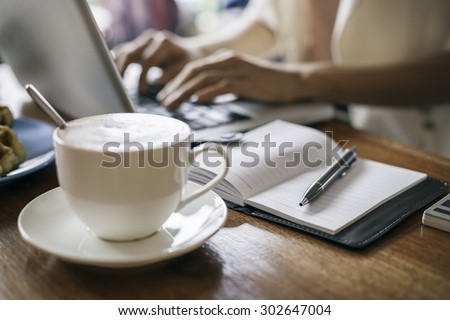 woman working on a laptop in a coffee shop