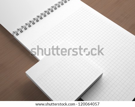 White blank notebook on wooden background