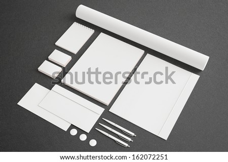 Blank Stationery Corporate ID set on dark background with soft shadows. Consist of Business cards, A4 letterheads, envelopes, notebook, tube, pens and folder.
