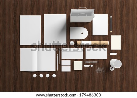 Blank stationery set on wooden background. Consist of folder, note, magazine, bag, business cards, pencil, cd disk, buttons, envelopes, tubus.