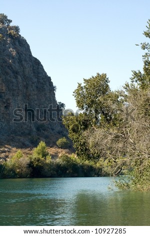 Photo of river bend rounded by mountains and trees
