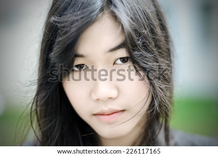 close up of beautiful young asian woman face in vintage background