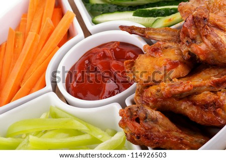 Chicken Wings Platter with Barbecue Dressing, Cucumber, Bell Pepper and Carrot Sticks closeup