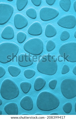 Background of Blue Droplet Shaped Stone on Cement Wall closeup