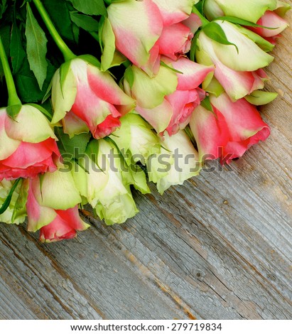 Corner Border of Beauty Pink And White Roses closeup on Rustic Wooden background