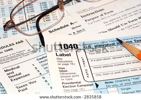 federal tax forms with glasses and pencil