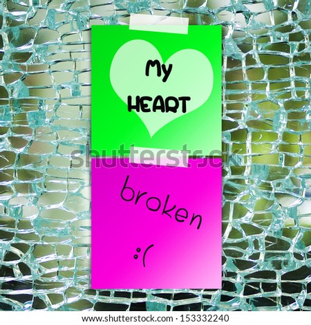 Broken heart text on sticky paper with broken glass background