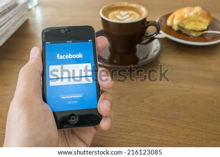 CHIANG MAI, THAILAND - SEPTEMBER 05, 2014: Facebook application login screen on iPod touch apple product with hand holding.