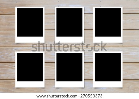 Polaroid photo frame on wood background