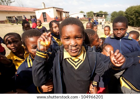 PIGGS PEAK, SWAZILAND-JULY 29: Unidentified orphan Swazi schoolboys on July 29, 2008 in Nazarene School, Piggs Peak, Swaziland. Close to 10% of Swazilands population are orphans, due to HIV/AIDS.