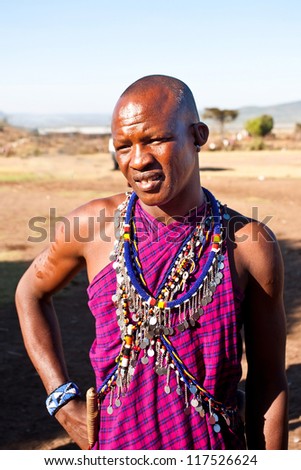 MAASAI MARA, KENYA - OCT 15: Portrait of unidentified Maasai man on Oct 15, 2012 in Maasai Mara, Kenya. Maasai are a Nilotic ethnic group of semi-nomadic people located in Kenya and northern Tanzania