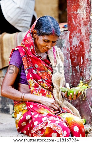 VARANASI - APRIL 23: Indian woman taking lunch on a local market on April 23, 2011 in Varanasi, India. India ranks second worldwide in farm output. Agriculture employs 52.1% of the total workforce