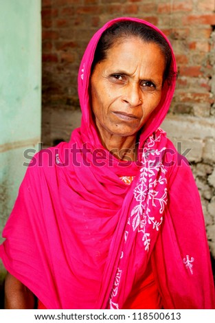 RAXAUL - OCT 19: Indian woman in front of her house on October 19, 2011 in Raxaul, Bihar state, India. Bihar is one of the poorest states in India. The per capita income is about 115 dollars.