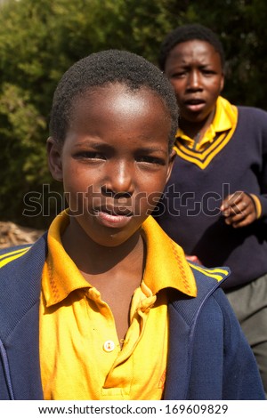 PIGGS PEAK, SWAZILAND-JULY 29: Unidentified Swazi schoolgirl on July 29, 2008 in Nazarene Mission School, Piggs Peak, Swaziland. Close to 10% of SwazilandÃ¢Â?Â?s population are orphans, due to HIV/AIDS.