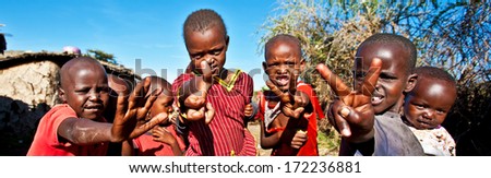 MAASAI MARA, KENYA - OCT 15: Unidentified Maasai children on Oct 15, 2012 in Maasai Mara, Kenya. Maasai are a Nilotic ethnic group of semi-nomadic people in Kenya and northern Tanzania.