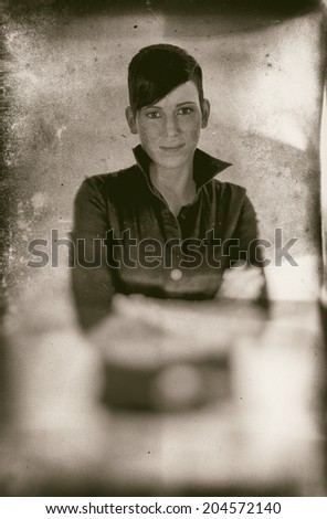 Vintage style black and white image of a beautiful short haired young Caucasian woman, over white background